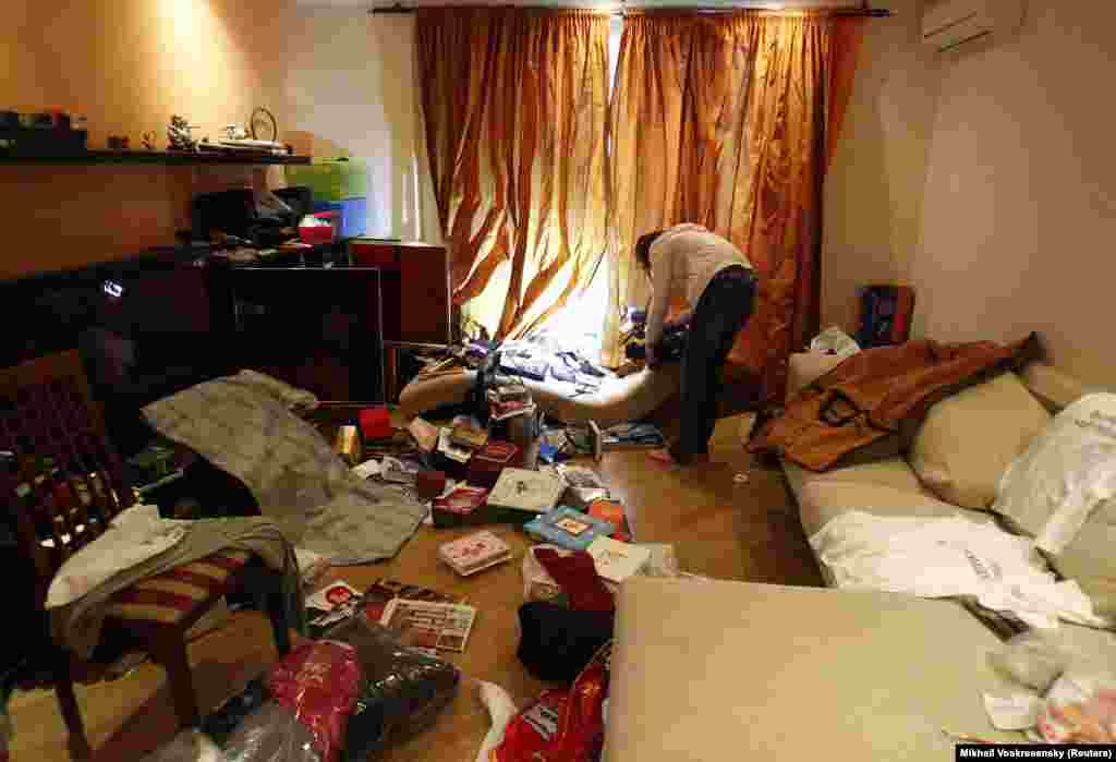 A journalist films Navalny’s Moscow apartment after it was ransacked by police on June 11, 2012. Russian police raided several opposition leaders' homes amid widespread anti-government protests in the spring and summer of 2012. 