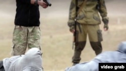 A capture from the Islamic State video purporting to show the execution of what it describes as two Russian spies.
