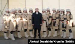 Russian President Vladimir Putin (center) poses with participants in celebrations to mark the Battle of Stalingrad during a visit to the Russia-My History museum in Volgograd in February 2018.