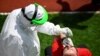 A Kosovar soccer referee gets tested for COVID-19 at a stadium in Pristina.