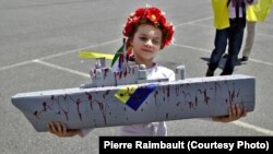 A young girl was one of but a handful of participants in a demonstration in Saint-Nazaire in June against the sale of French-built Mistral warships to Russia.