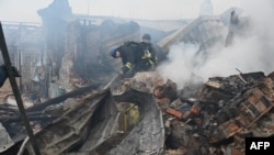 Ukrainian rescue workers tackle a blaze in a private house after a Russian drone attack on Kharkiv. (file photo)