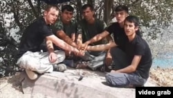 A screen grab from an extremist propaganda video showing Abdusamadov (center) and the other suspects in the attack.