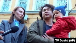 Dmitry Prokazov and Olga Prokazova with one of their children. (file photo)