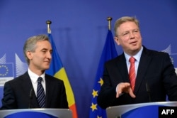 Moldovan Prime Minister Iurie Leanca (left) and EU Enlargement Commissioner Stefan Fuele speak to reporters in Brussels on June 14.