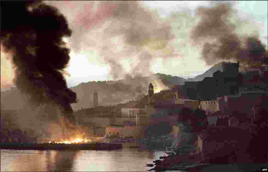 The Croatian town of Dubrovnik burns after bombardment from the Yugoslav Navy in 1991. From 1991 until 2001, the former Yugoslavia was wracked by a series of interethnic wars and insurgencies which ended in the deaths of an estimated 130,000 people and the formation of several independent successor states to Yugoslavia. 