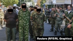 Correspondents say people watching the August 24 incident in Donetsk shouted "Fascists!" and other abuse at the prisoners.