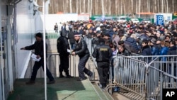 Migrants wait to register at a migration center in Sakharovo, a village about 60 kilometers (35 miles) south of Moscow in 2015.