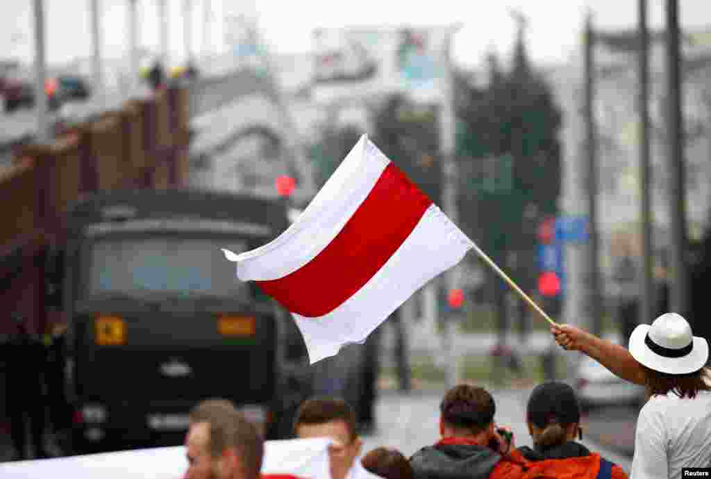 Many of the demonstrators were waving red-and-white flags and banners, which have become a symbol of the protest movement. 