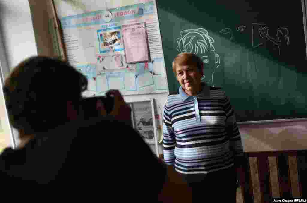 The day before, van Helten had visited a local school to photograph Marina Marchenko, whom he chose after seeing a photograph of the 73-year-old teacher. "I could just see the kindness in her eyes...I want my work to have a local identity."