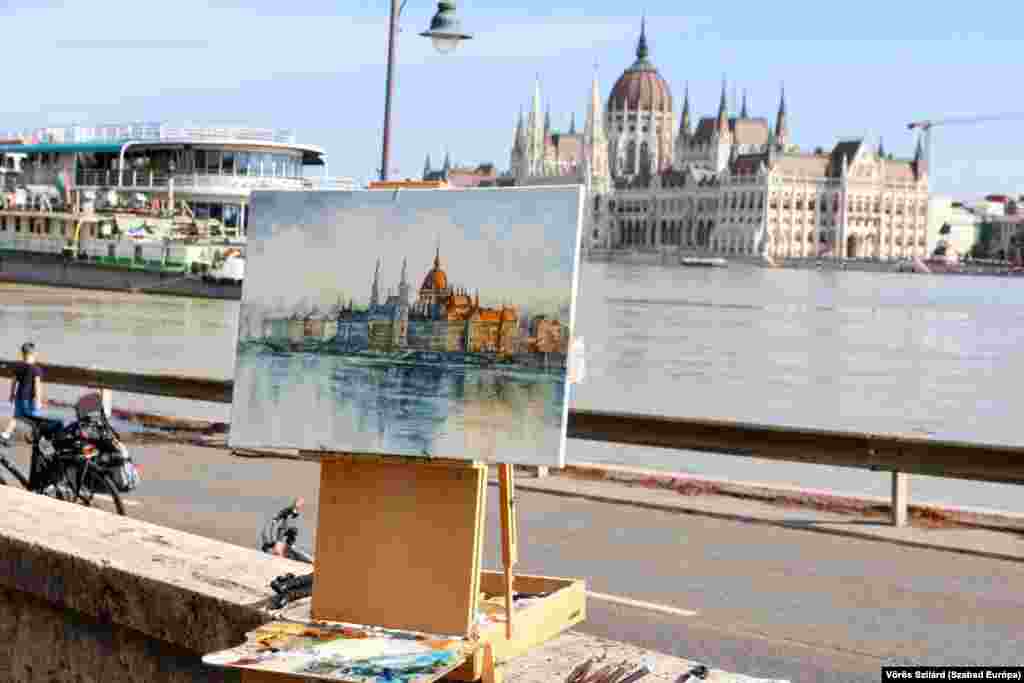 A painting by Ukrainian artist and ex-soldier Peter Kozlovskiy shows the flooded Danube River at the Hungarian parliament in Budapest. 