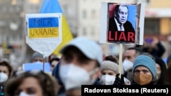 Людина тримає плакат із зображенням міністра закордонних справ Росії Сергія Лаврова під час антивоєнного мітингу після вторгнення Росії в Україну в Братиславі, Словаччина, 11 березня 2022 року