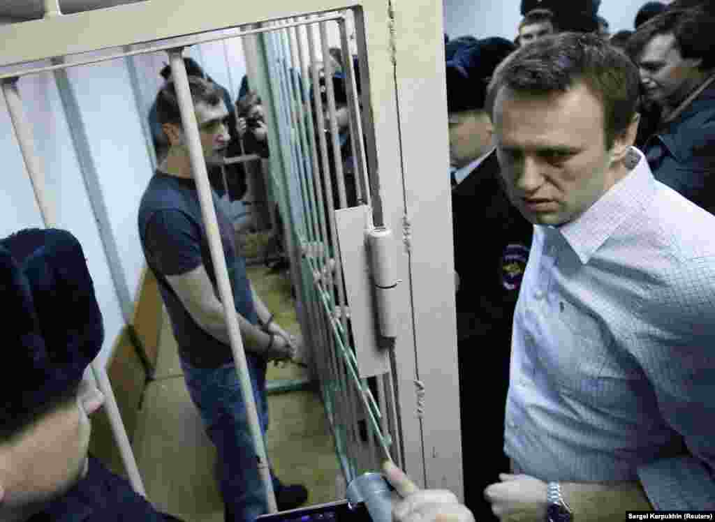 Navalny and his brother Oleg (inside cage) during a court hearing in Moscow in December 2014. The pair were convicted of stealing around $500,000 from Russian firms during business dealings dating back several years. They rejected the charges. Aleksei Navalny’s sentence was suspended, but his brother served a full prison term of 3 1/2 years, being released in June 2018. 