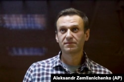 Russian opposition leader Aleksei Navalny stands in a cage in a Moscow court in February, before being sent to a notorious prison east of Moscow.