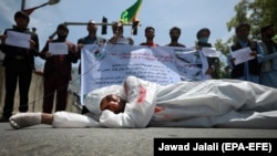 An Afghan man protests the migrant deaths outside the Iranian Embassy in Kabul on May 7.