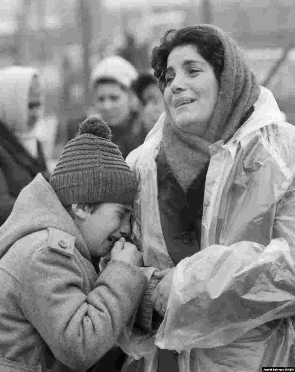 Grieving locals near their destroyed house. Gorbachev declared, "In my entire life, I've never seen one-thousandth of the suffering I've seen here.”