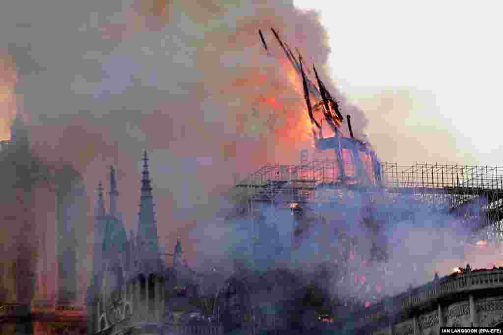 The spire collapses in flames during the blaze on April 15, 2019.