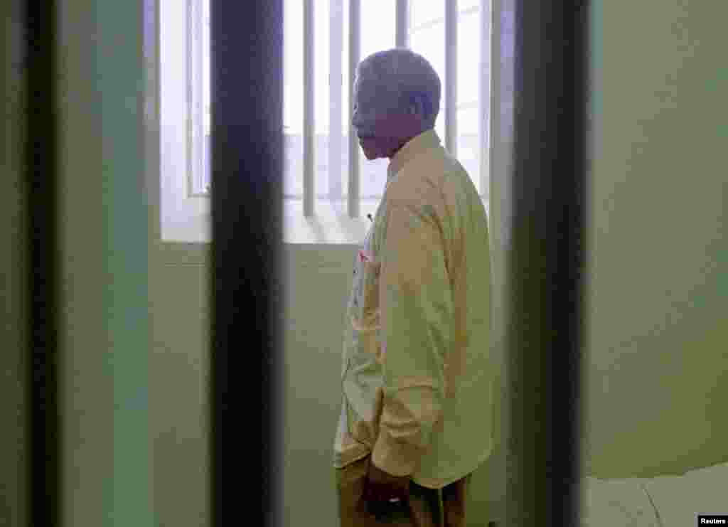 Nelson Mandela stares out of the window of the prison cell he occupied on Robben Island for a large portion of his 27-year incarceration in 1994.