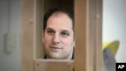 Wall Street Journal reporter Evan Gershkovich stands in a glass cage in a courtroom at the Moscow City Court in December.
