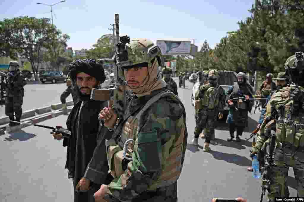 Taliban fighters wearing modern ballistic helmets and carrying U.S.-made weapons at a checkpoint in Kabul on August 29. 