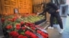 A man lays flowers to Azerbaijan's Embassy in Moscow paying tribute to the victims of an Azerbaijan Airlines' plane crash.
