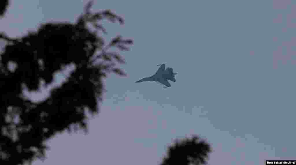 A Russian fighter jet flies over the Hmeimim air base. "When a big cargo plane is landing or taking off, a fighter jet takes off first and guards the airport by circling around the airfield," Bektas says. 