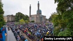 Russian Muslims, who are the second largest denomination in the country, pray outside a mosque as they celebrate Eid al-Adha in St. Petersburg in July. 