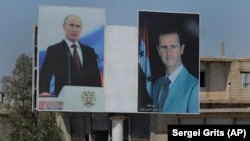 Сириянын президенти Башар Асад менен Орусиянын президенти Владимир Путиндин портреттери, 15-август, 2018-жыл, Сирия.