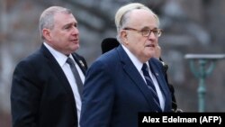 U.S. President Donald Trump's personal lawyer Rudy Giuliani (right) with Soviet-born businessman Lev Parnas at the funeral of President George Bush in Washington in 2018. 