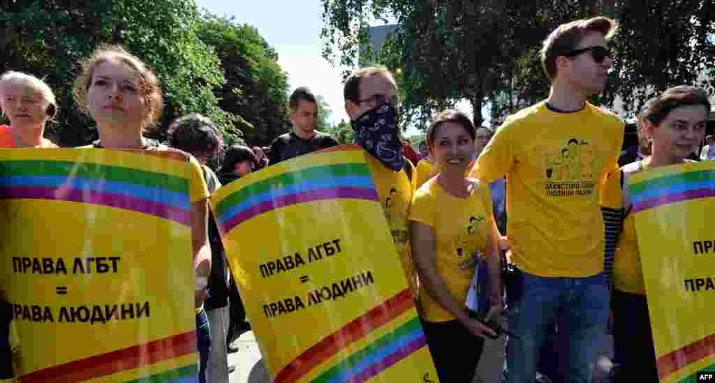 Activists carry placards saying "Lesbian and gay rights are human rights" during the gay-pride parade in the Ukrainian capital. 