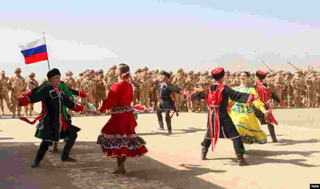 A traditional dance group performs for the troops. 