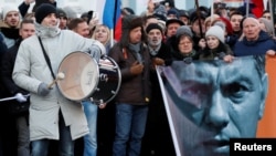 People take part in a rally to mark the anniversary of Russian opposition politician Boris Nemtsov's murder in Moscow on February 29.