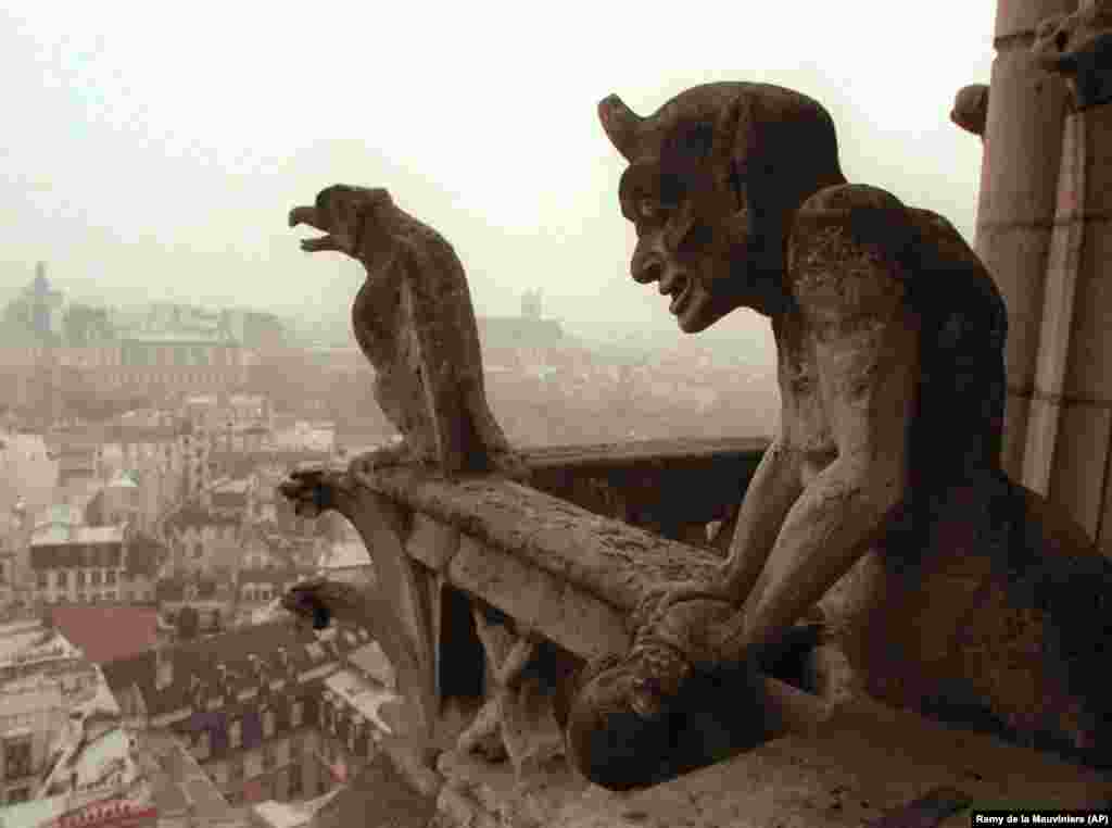 Gargoyles watch over the streets of Paris from the facade of the cathedral in 1996.