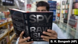 A customer in an Islamabad bookstore looks at Spy Chronicles, a new tell-all tome by former Indian and Pakistani intelligence chiefs that has caused a storm in both countries. 