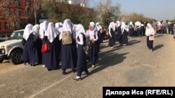 Schoolgirls protest against having to take off their hijab to enter school in the Turkestan region in September 2018.
