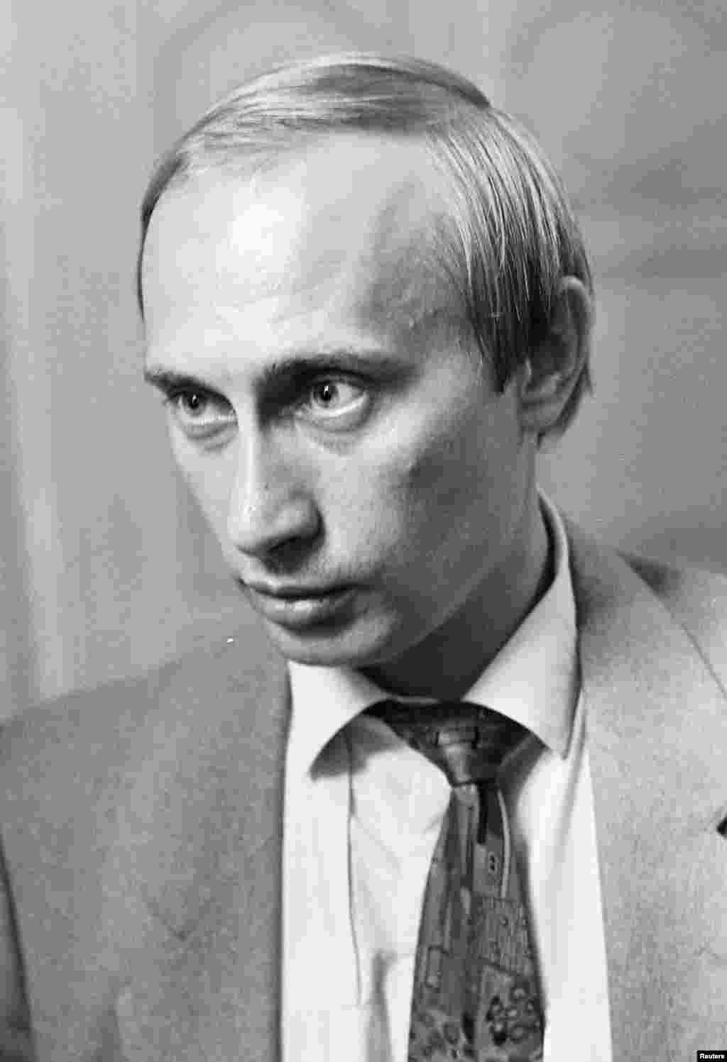 Vladimir Putin, chairman of St. Petersburg's External Relations Committee, looks on at Mariinsky Palace in St. Petersburg on August 20, 1991.