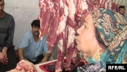 A Tajik woman buys beef at a market in Dushanbe (file photo)