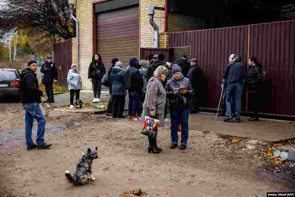 People wait to submit their DNA to identify their deceased relatives in the town of Izyum, in Ukraine's northeastern Kharkiv region, on November 4. 