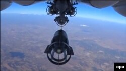 Bombs are dropped by a Russian warplane during an air strike near Idlib on October 5.