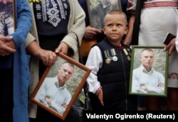 Relatives hold portraits of a Ukrainian serviceman who was killed in the conflict in eastern Ukraine during a rally in August 2020 to commemorate the sixth anniversary of the Battle of Ilovaysk.