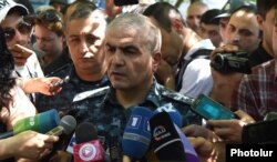 General Hunan Poghosian, the first deputy chief of the Armenian police, speaks to reporters near a police building in Yerevan seized by antigovernment gunmen.