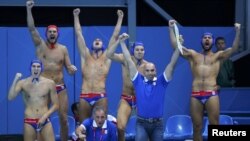 Serbia's bench celebrates a goal against Australia during their quarterfinal water-polo match.
