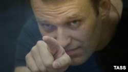 Russian opposition leader Aleksei Navalny gestures inside a glass-walled cage during his court hearing in Kirov on July 19