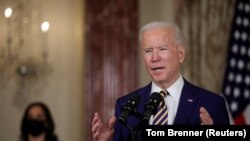 U.S. President Joe Biden delivers a foreign policy address as Vice President Kamala Harris listens during a visit to the State Department in Washington on February 4. 