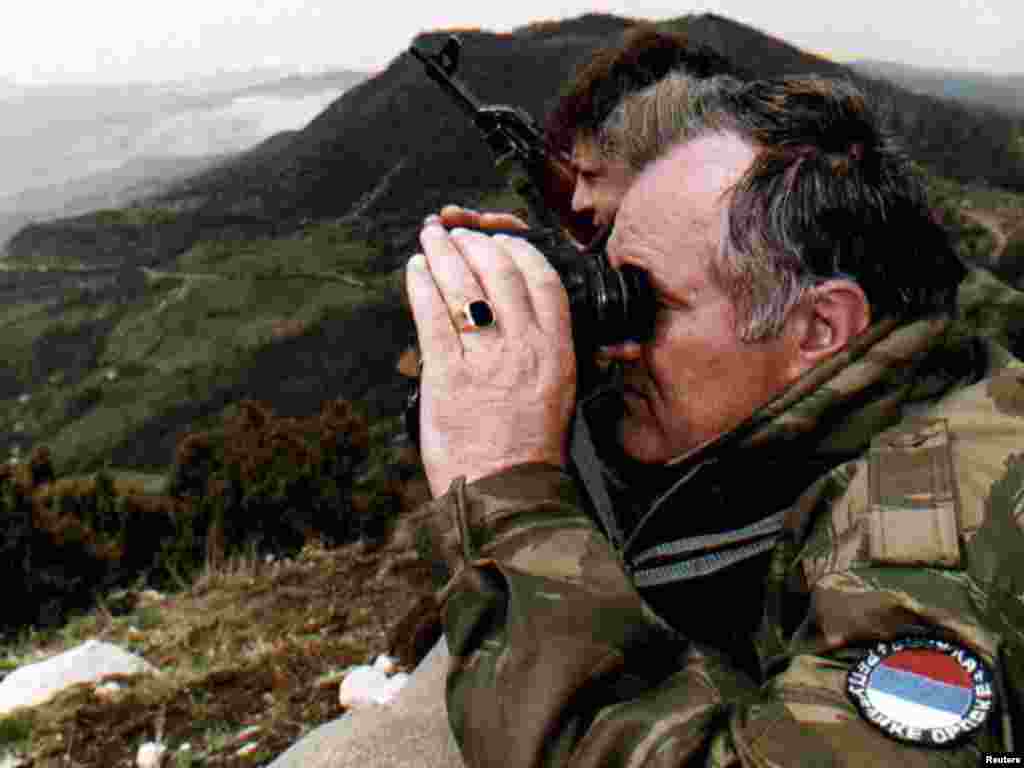 Mladic monitors a battle against Muslim forces from atop a hill some 4 km from the center of the eastern Bosnian city of Gorazde on April 16, 1994.