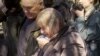 Relatives mourn victims of a deadly Russian missile strike on Sumy at a funeral service on April 15. 