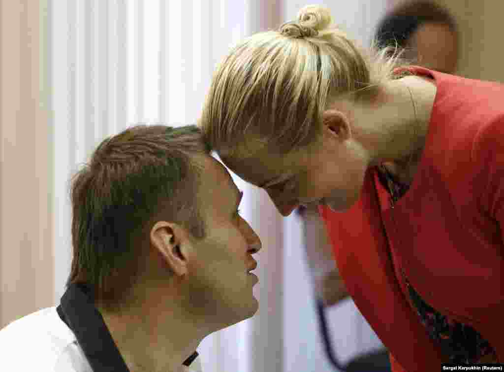 Navalny and his wife, Yulia, during a break in court proceedings in Kirov in July 2013. Navalny was charged with stealing 16 million rubles ($500,000) from a state timber firm. He rejected the charges as trumped up. The court handed down a five-year prison term that was later reduced to a suspended sentence after widespread public protests. 