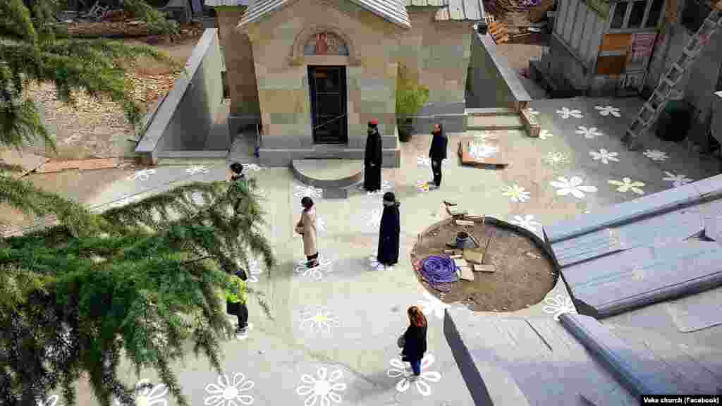 Flowers painted on the floor of Vake Church in the Georgian capital, Tbilisi, help visitors practice social distancing on March 25.