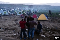 Refugees gather at a makeshift camp on the Greek-Macedonian border near the Greek village of Idomeni on March 1.