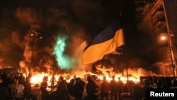 Antigovernment protesters gather in front of burning tires during clashes with riot police in Kyiv on the night of January 22-23.